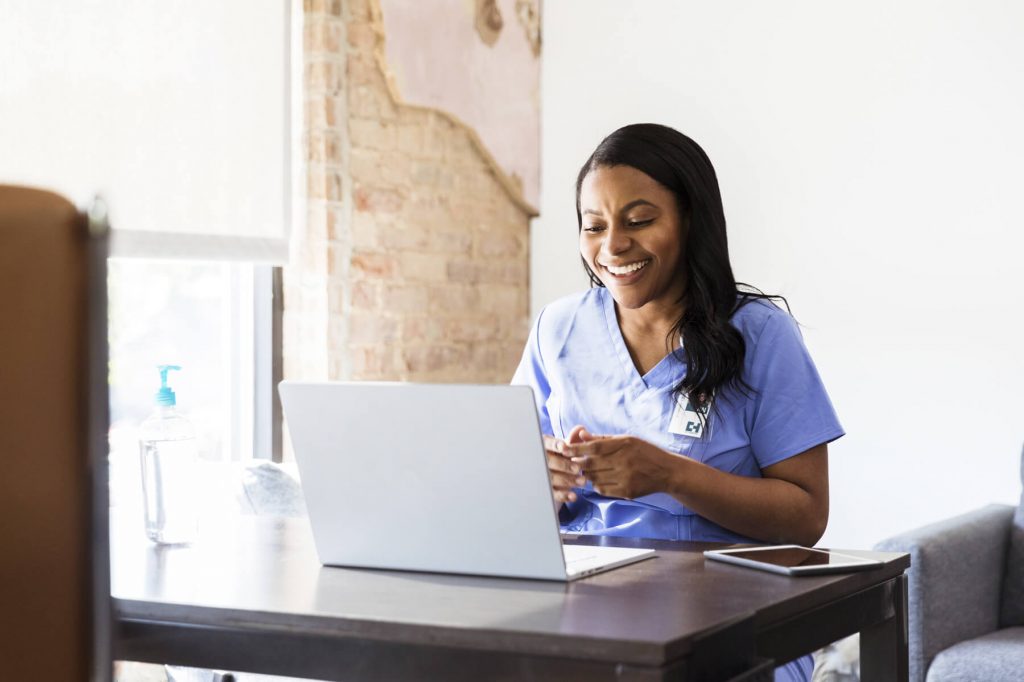Smiling nurse with laptop