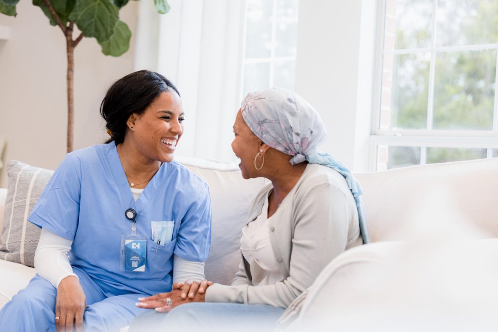 Smiling nurse and patient in conversation