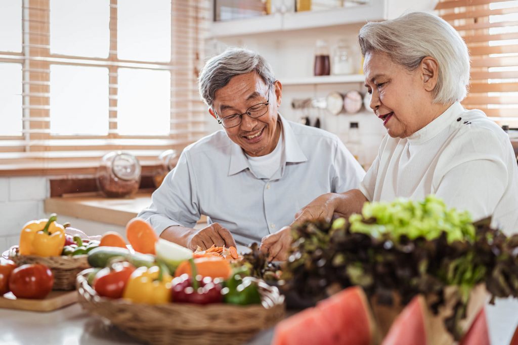 Senior couple in kitchen with healthy food choices