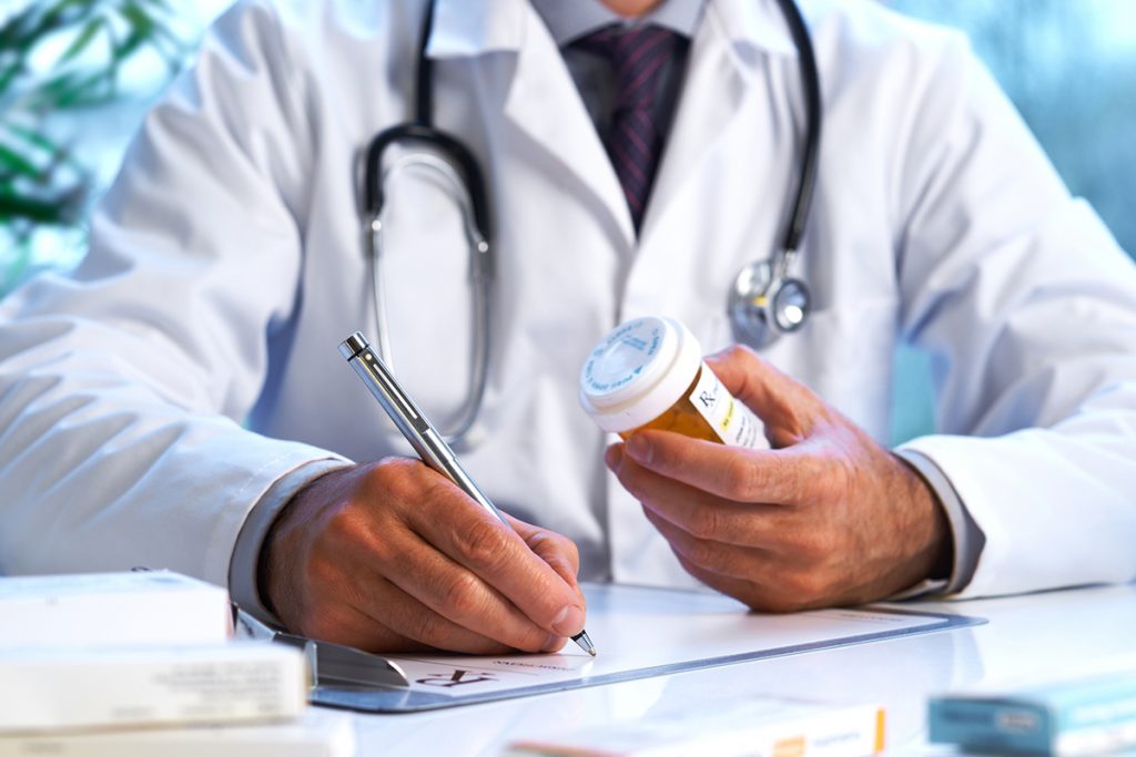 Doctor prescribing pain management medication